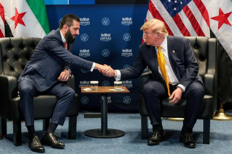 US President Donald Trump shakes hands with Syrian President Ahmed al-Sharaa.