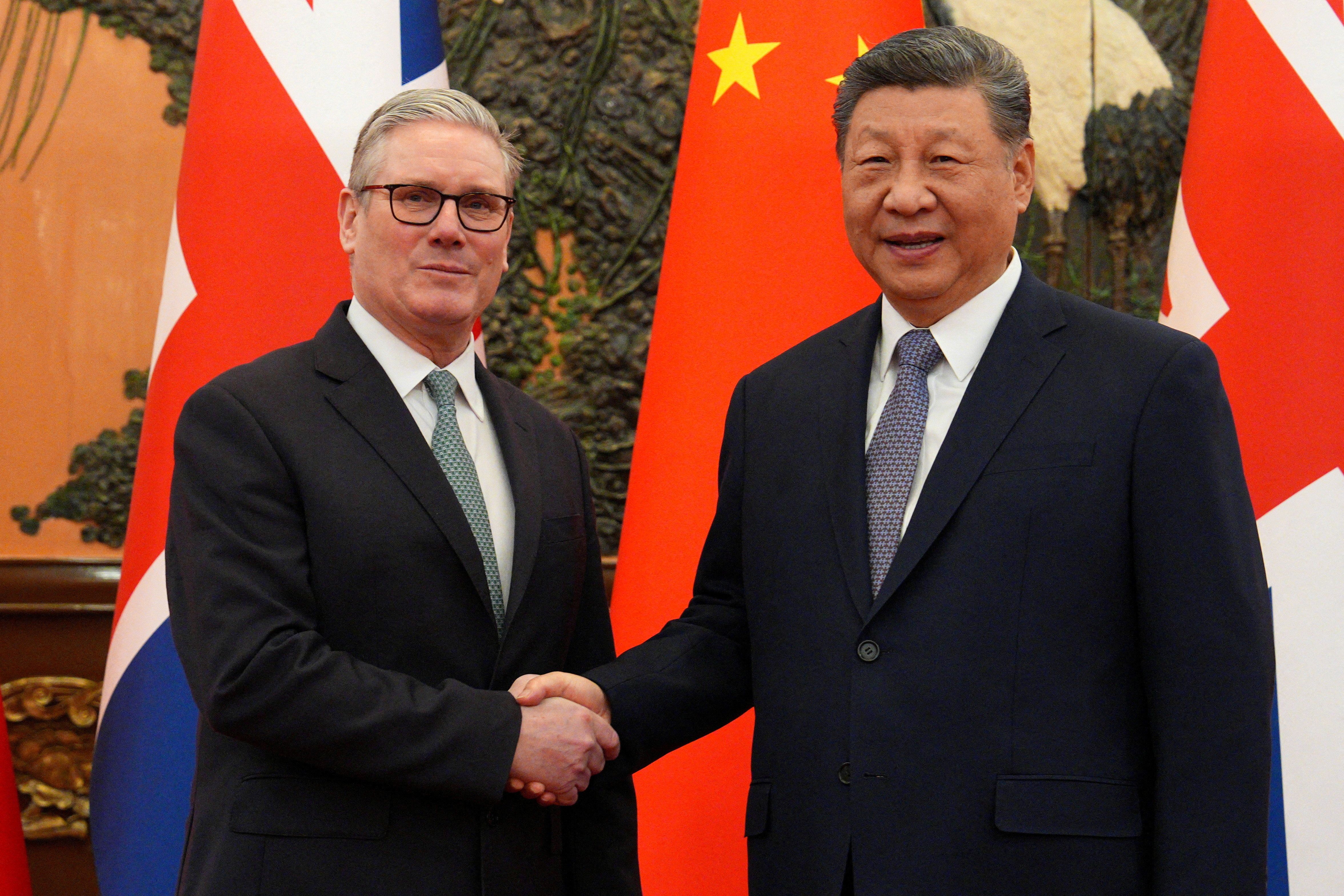Britain’s Prime Minister Keir Starmer shakes hands with Chinese President Xi Jinping.