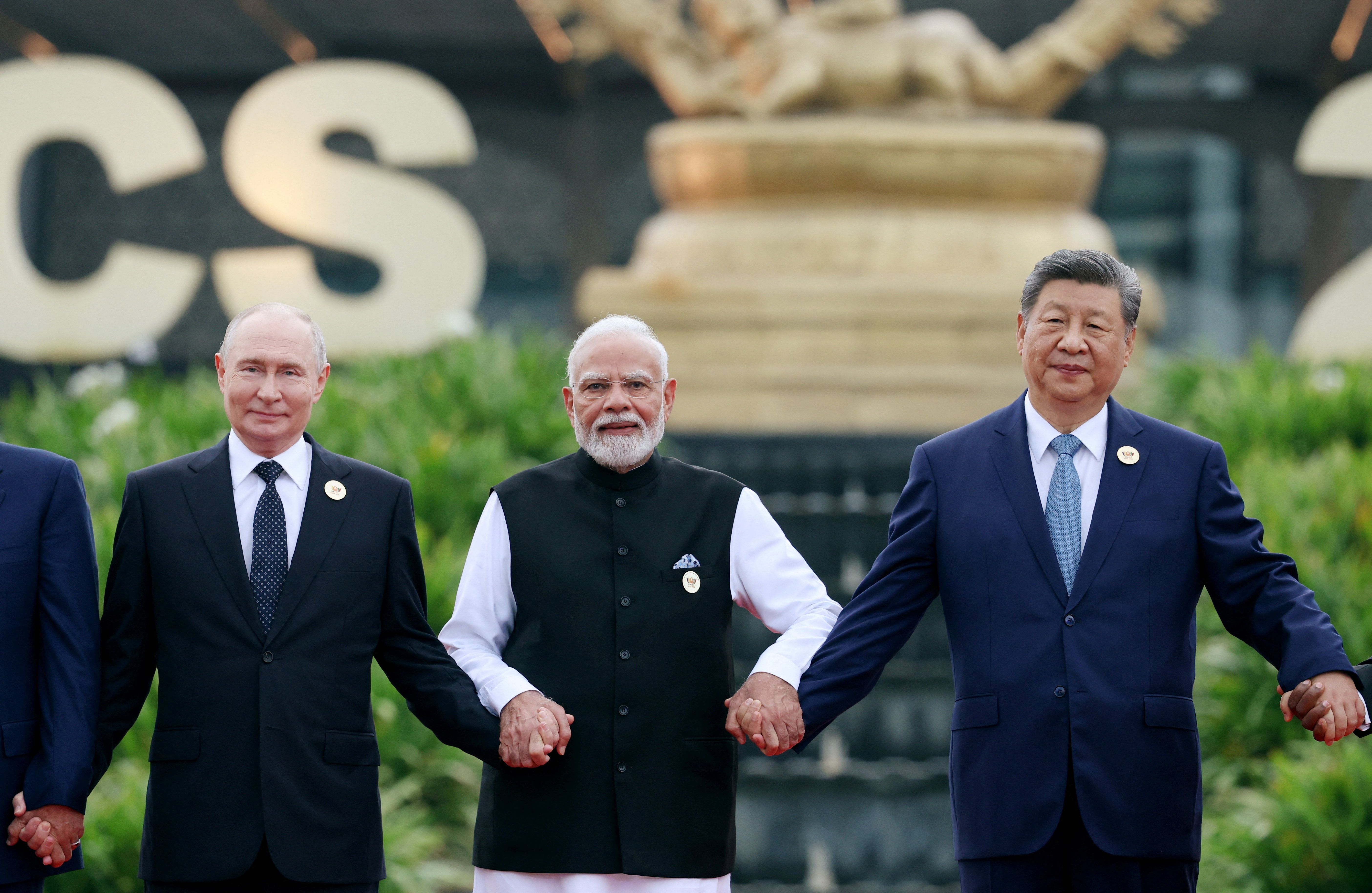 Russia’s President Vladimir Putin, India’s Prime Minister Narendra Modi and China’s President Xi Jinping pose