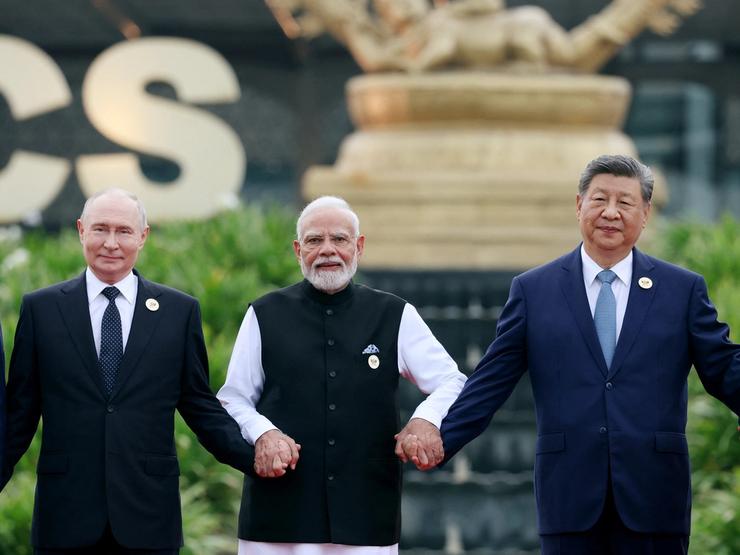 Russia’s President Vladimir Putin, India’s Prime Minister Narendra Modi and China’s President Xi Jinping pose