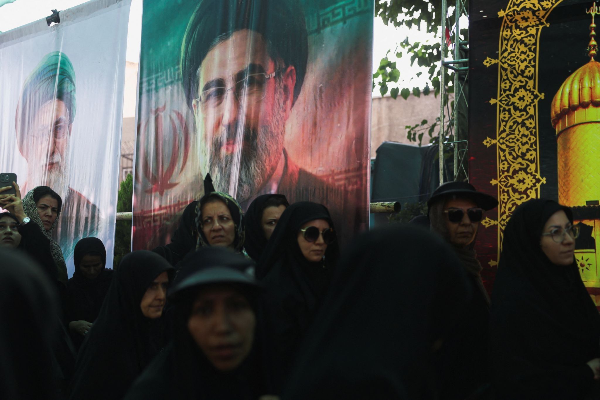 Banners depicting Iran’s late Supreme Leader Ayatollah Ali Khamenei and Iran’s Supreme Leader Mojtaba Khamenei.