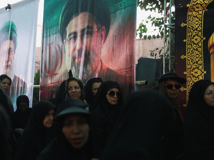 Banners depicting Iran’s late Supreme Leader Ayatollah Ali Khamenei and Iran’s Supreme Leader Mojtaba Khamenei.