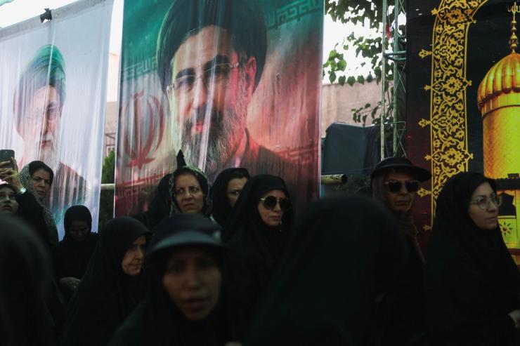Banners depicting Iran’s late Supreme Leader Ayatollah Ali Khamenei and Iran’s Supreme Leader Mojtaba Khamenei.