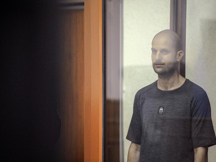 Evan Gershkovich stands inside an enclosure for defendants as he attends a court hearing in Yekaterinburg, Russia, on July 19, 2024.