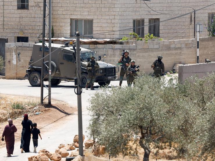 Israeli soldiers take part in raid following settler attacks in al-Mughayyir in the Israeli-occupied West Bank