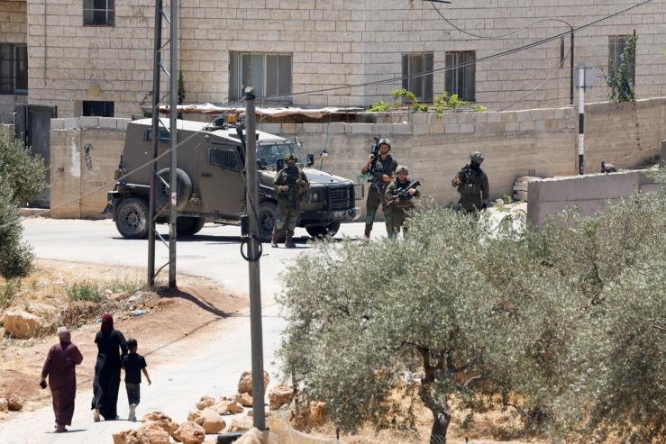 Israeli soldiers take part in raid following settler attacks in al-Mughayyir in the Israeli-occupied West Bank