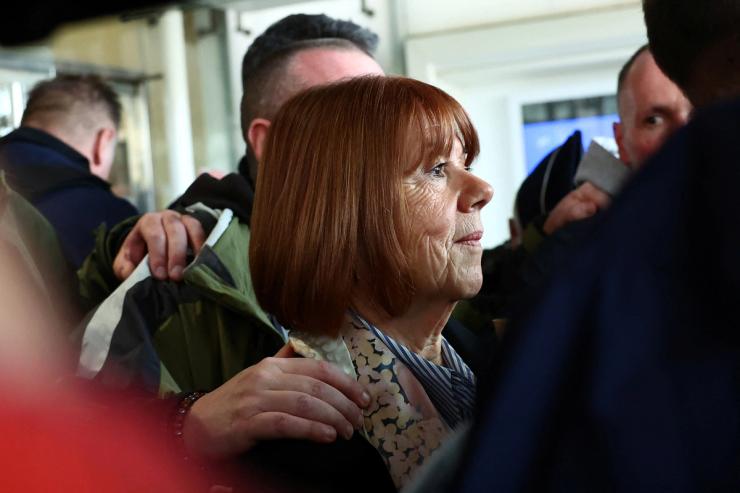 Gisele Pelicot leaves the courthouse surrounded by French police after the verdict in the mass rape trial for her ex-husband Dominique Pelicot and 50 co-accused.