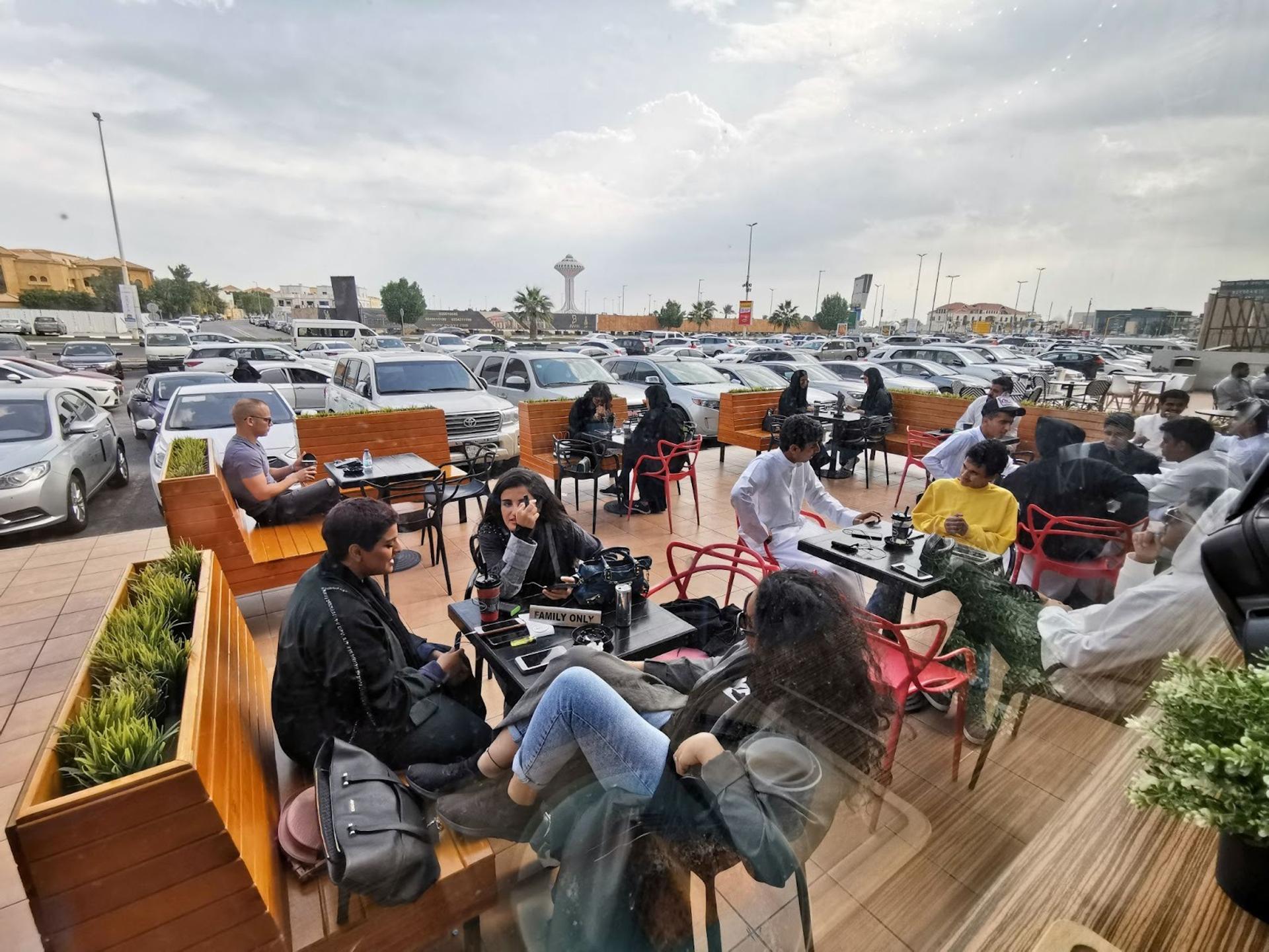 Saudi men and women sit at a cafe in Khobar.