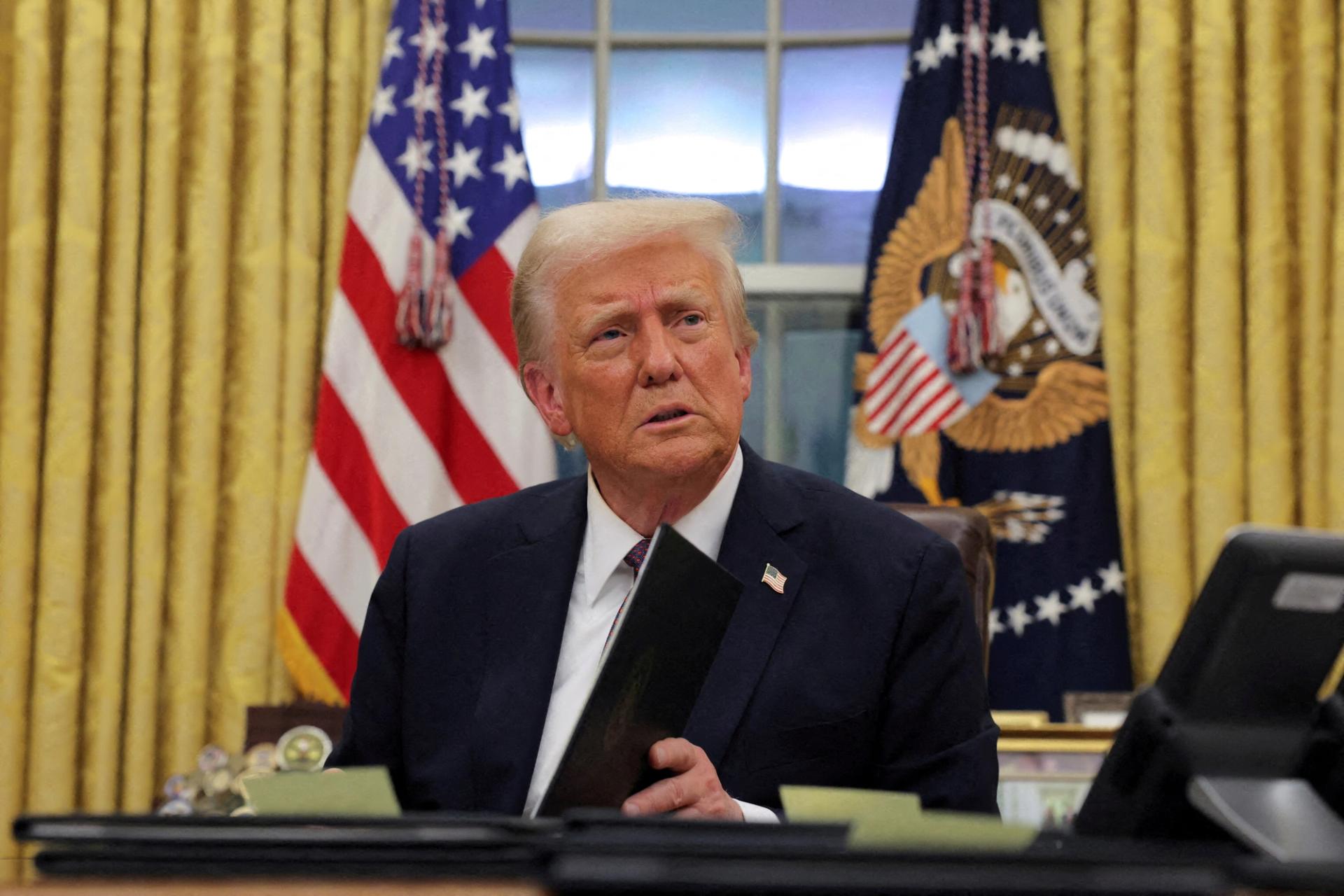 U.S. President Donald Trump signs documents at the Oval Office, Washington DC, US, 2025.