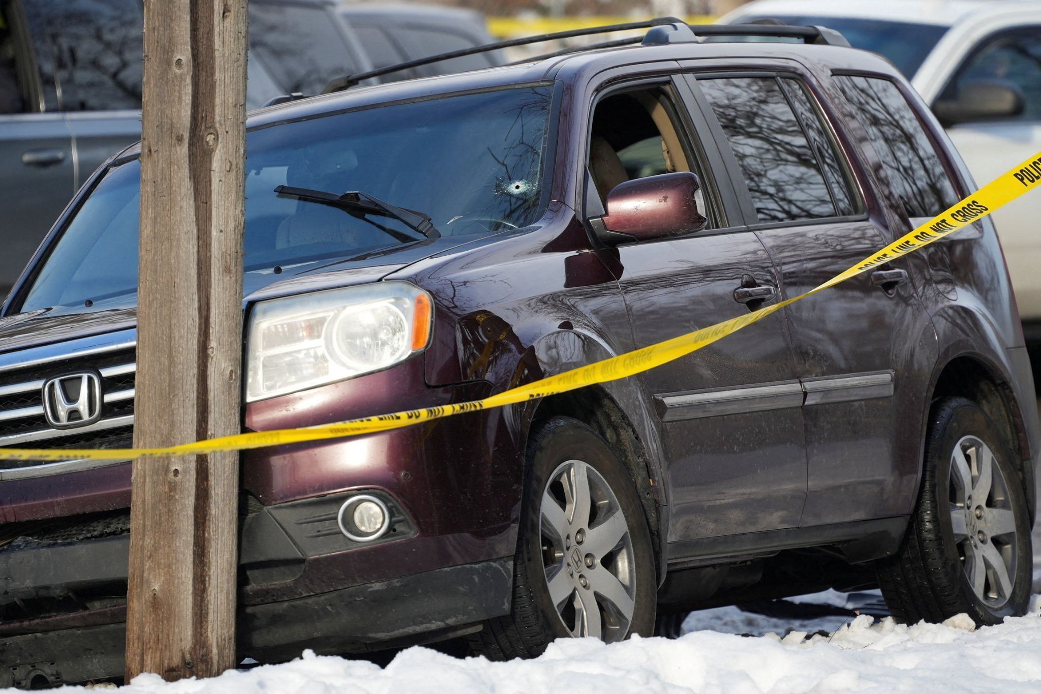 A vehicle with a bullet hole in the windshield after a driver was fatally shot by ICE. 