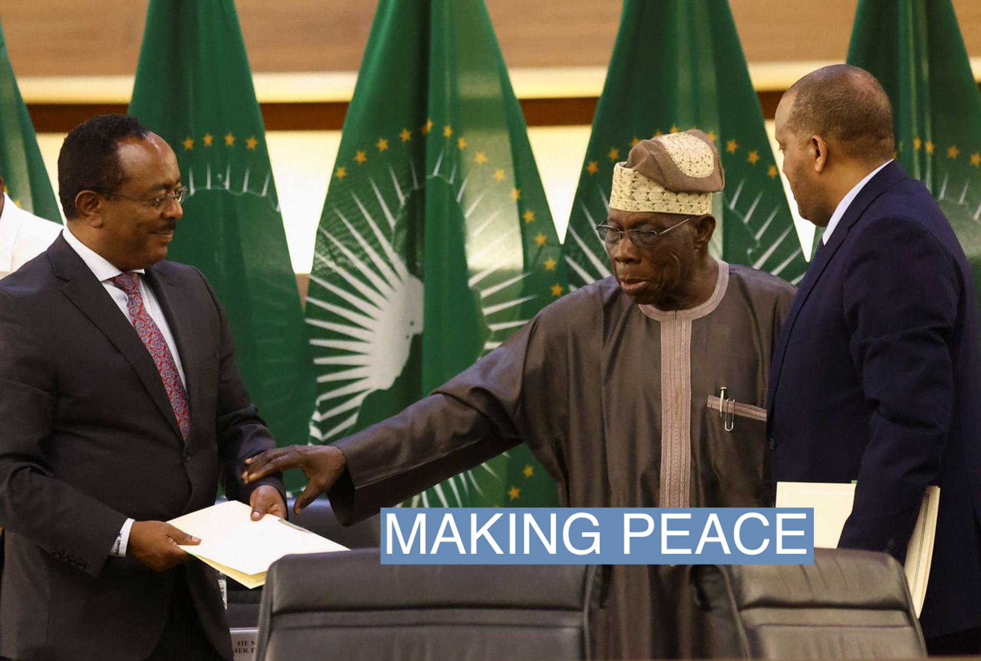 Former Nigerian president Olusegun Obasanjo gestures to Ethiopian government's Redwan Hussien and Tigray delegate Getachew Reda