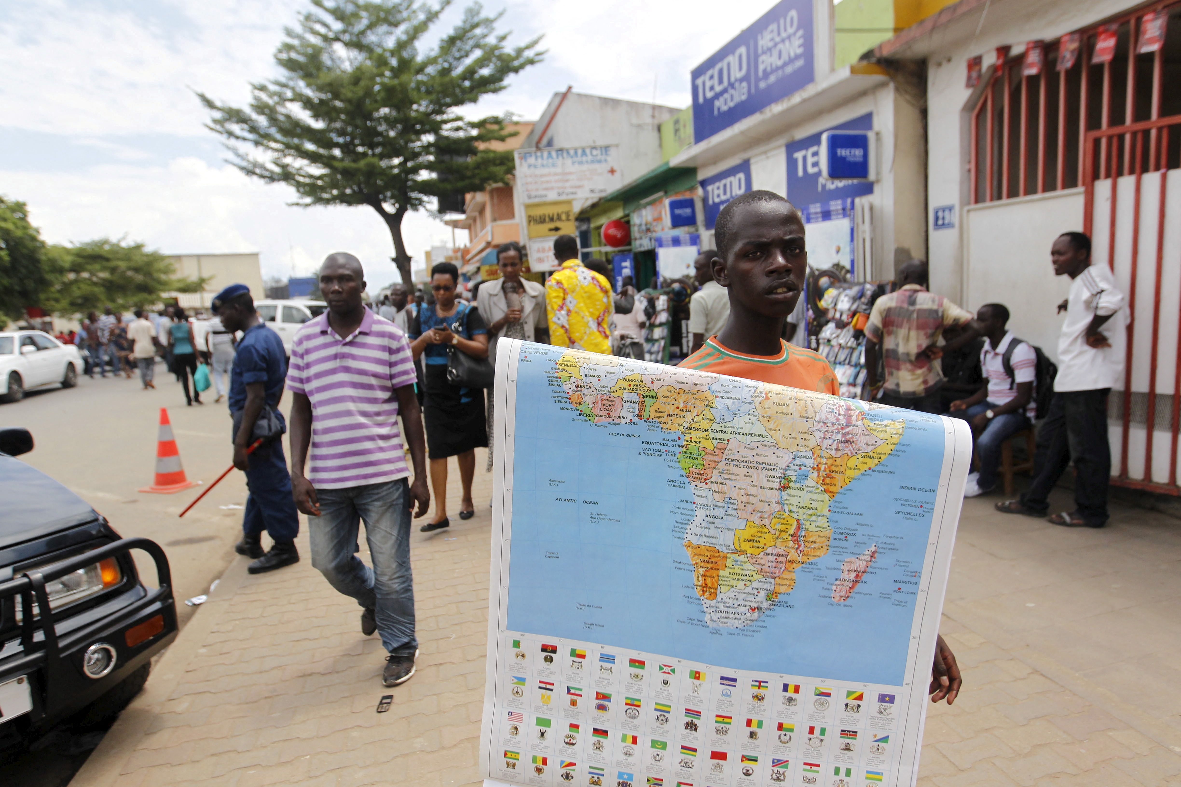 A vendor sells a map of Africa