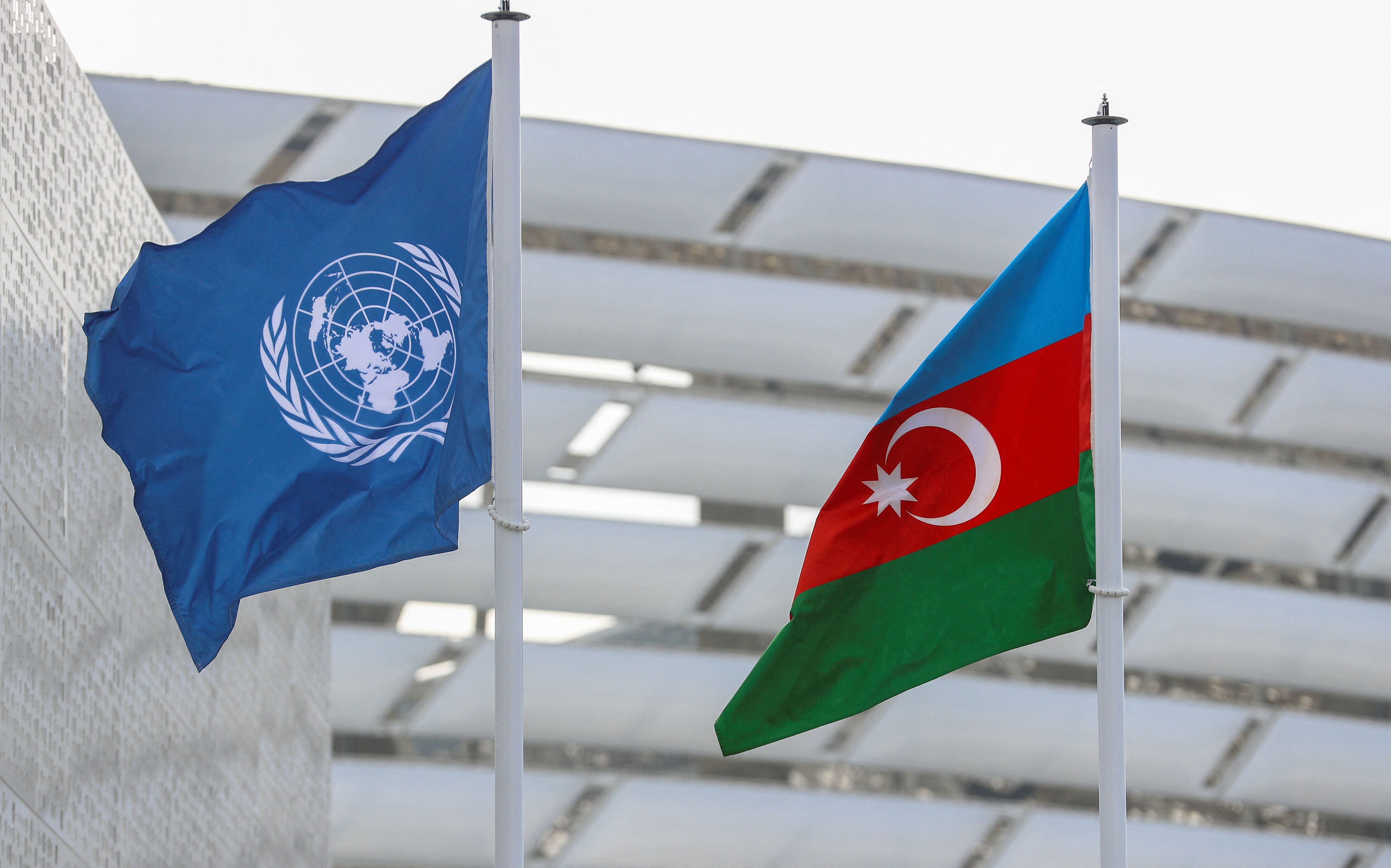 Flags of Azerbaijan and the United Nations fly near the COP29 summit venue in Baku, Azerbaijan.