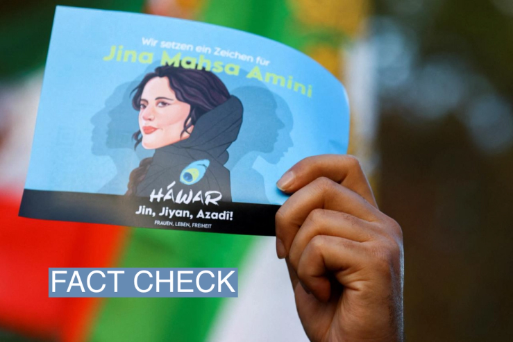 A demonstrator holds a poster during a protest following the death of Mahsa Amini in Iran, in Berlin, Germany, October, 22, 2022.