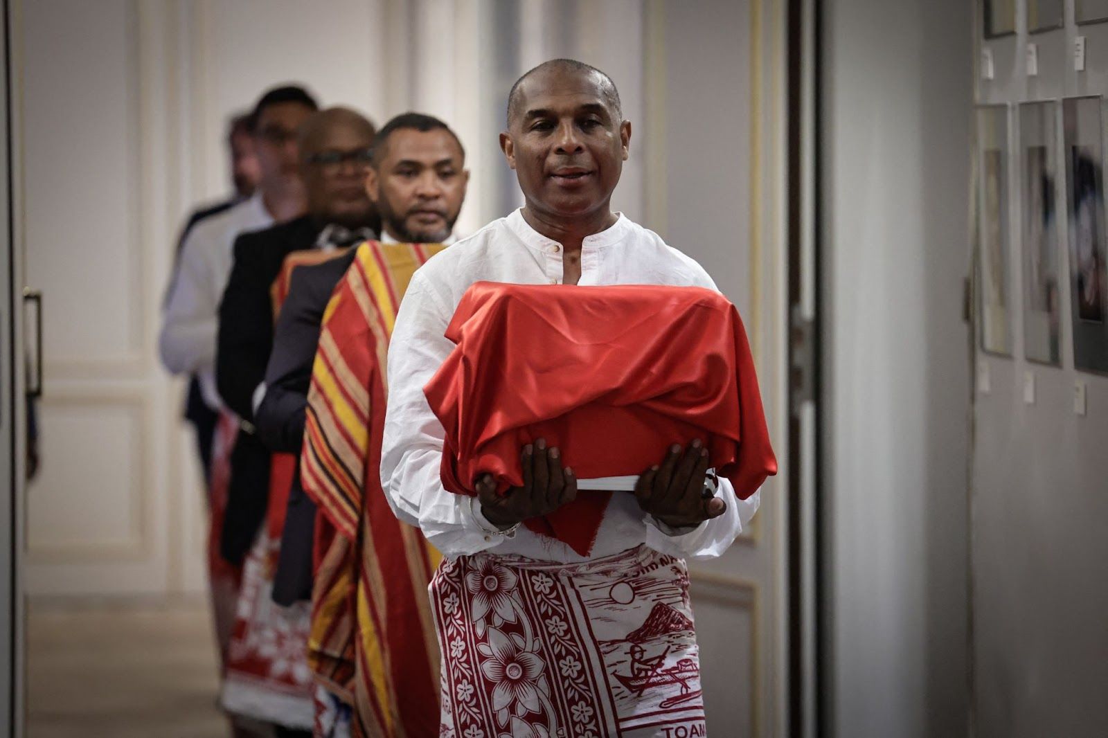 A man carries one of the three Sakalava skulls