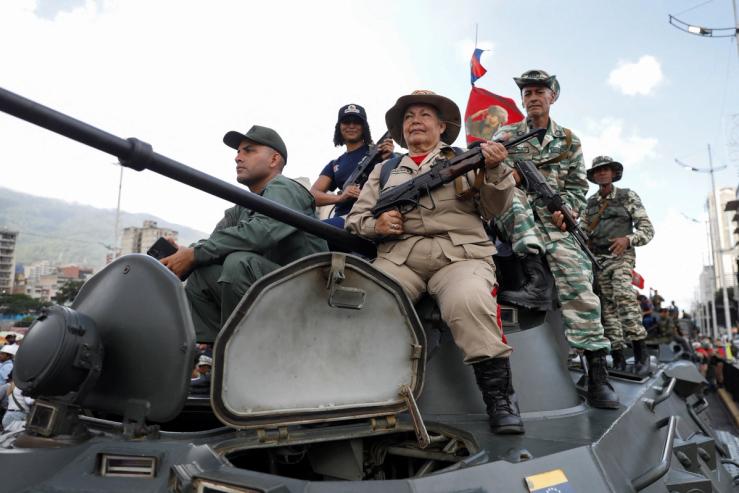 Members of the Bolivarian Militia, National Armed Forces and people on top of a tank take part in a rally of the Bolivarian National Militia in support of Venezuelan President Nicolas Maduro