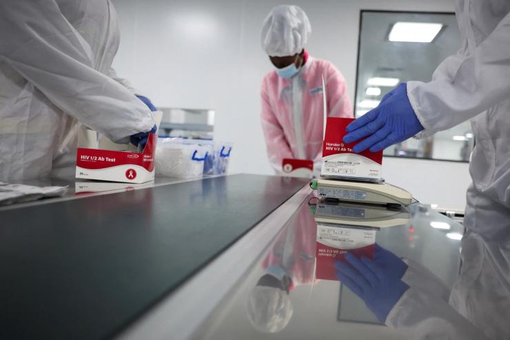 Workers pack HIV 1/2 test kits at Codix Bio production plant in Nigeria.