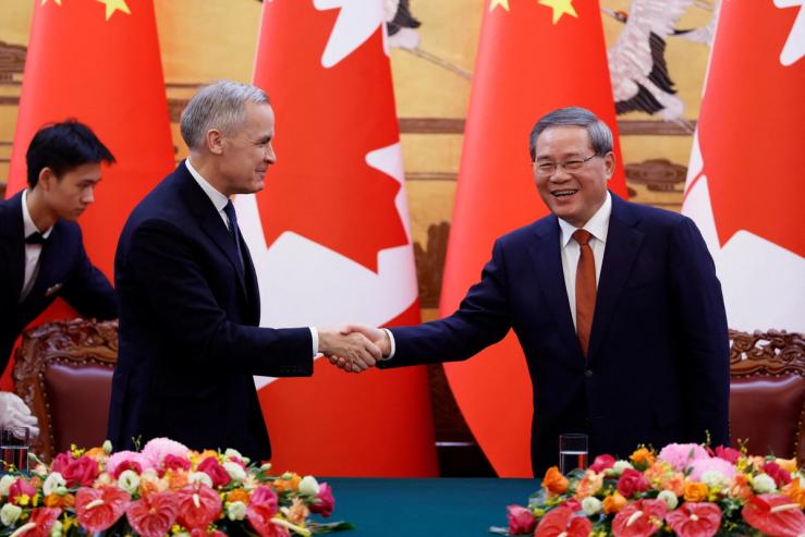 Canada’s Prime Minister Mark Carney shakes hands with China’s Premier Li Qiang