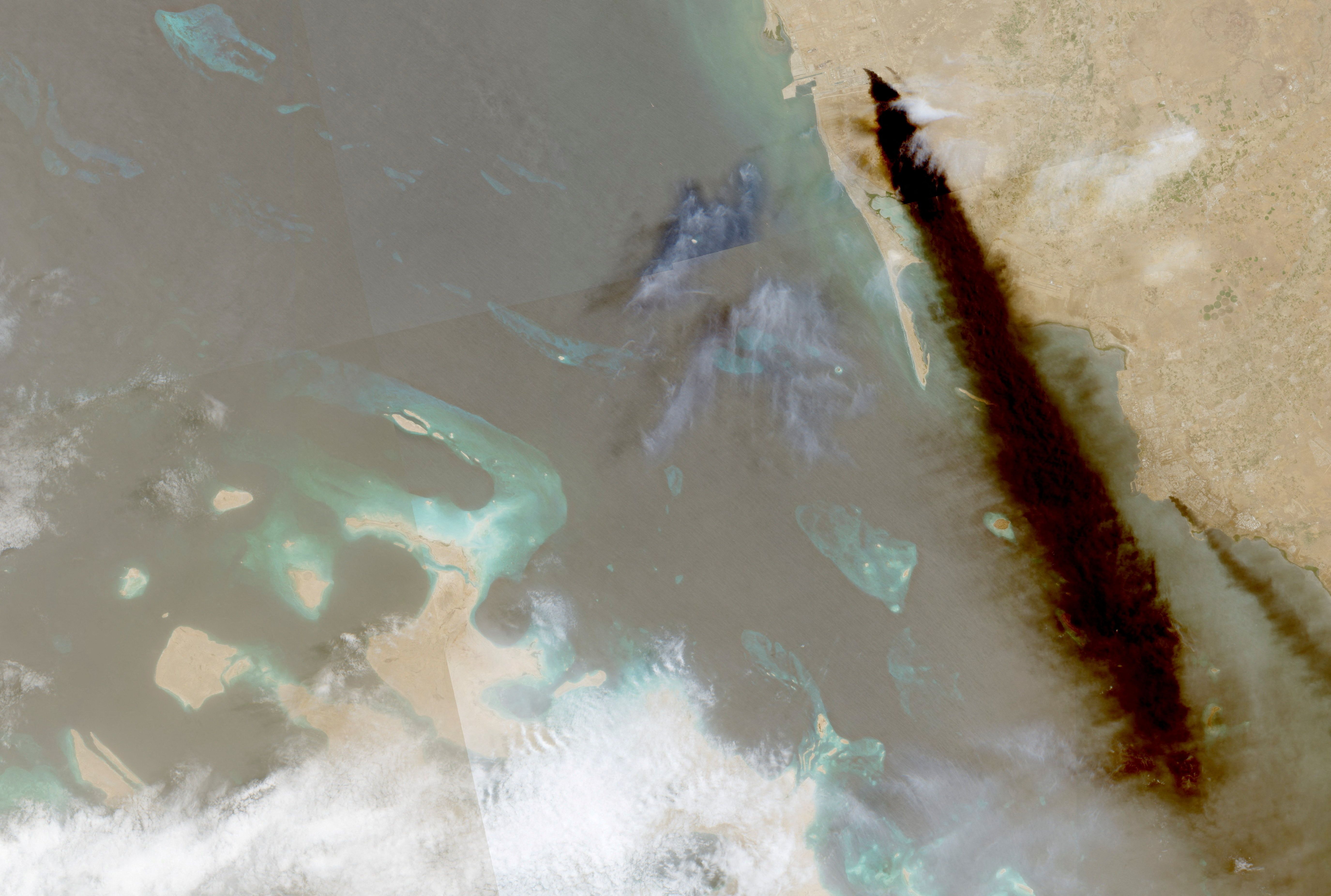 A composite satellite image shows trail of smoke rising from an oil facility, in Jizan, Saudi Arabia