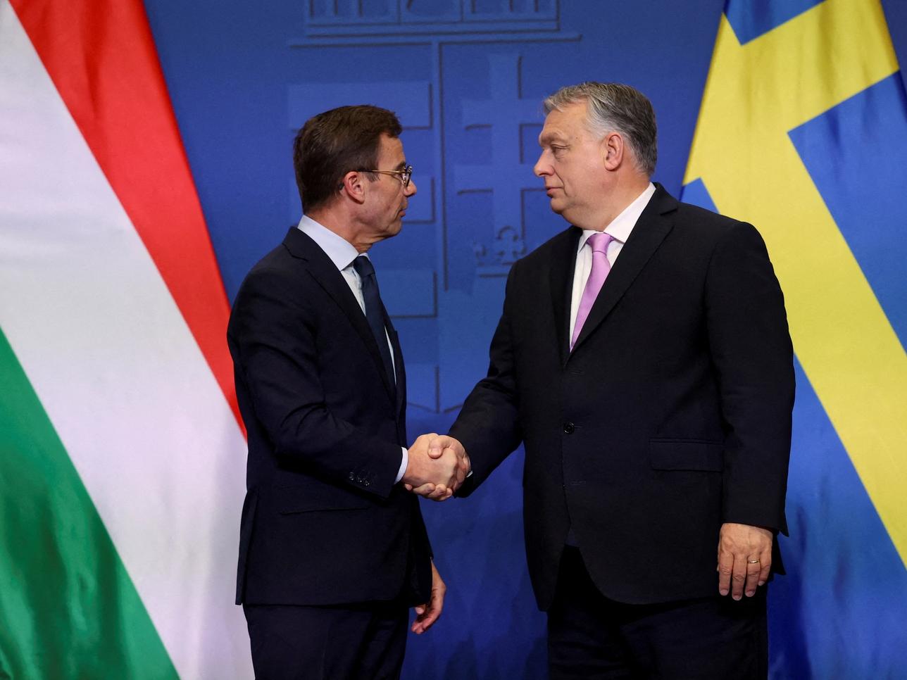 Swedish Prime Minister Ulf Kristersson and Hungarian Prime Minister Viktor Orban shake hands at a joint press conference in Budapest, Hungary, February 23, 2024. REUTERS/Bernadett Szabo