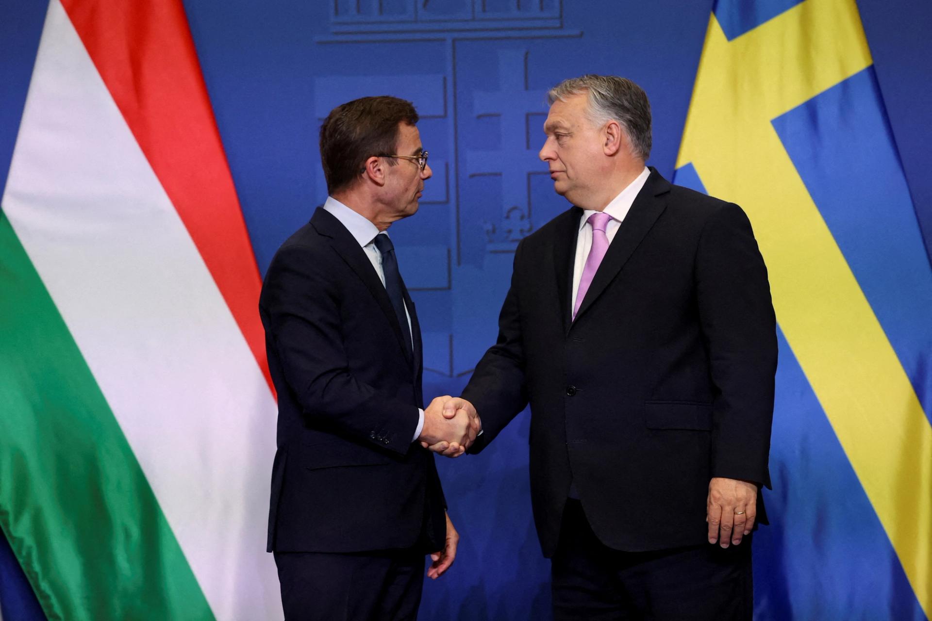 Swedish Prime Minister Ulf Kristersson and Hungarian Prime Minister Viktor Orban shake hands at a joint press conference in Budapest, Hungary, February 23, 2024. REUTERS/Bernadett Szabo