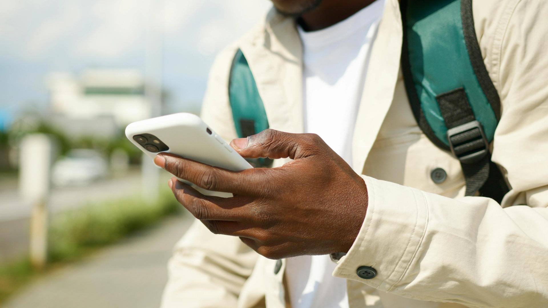 A person types on their smartphone. 