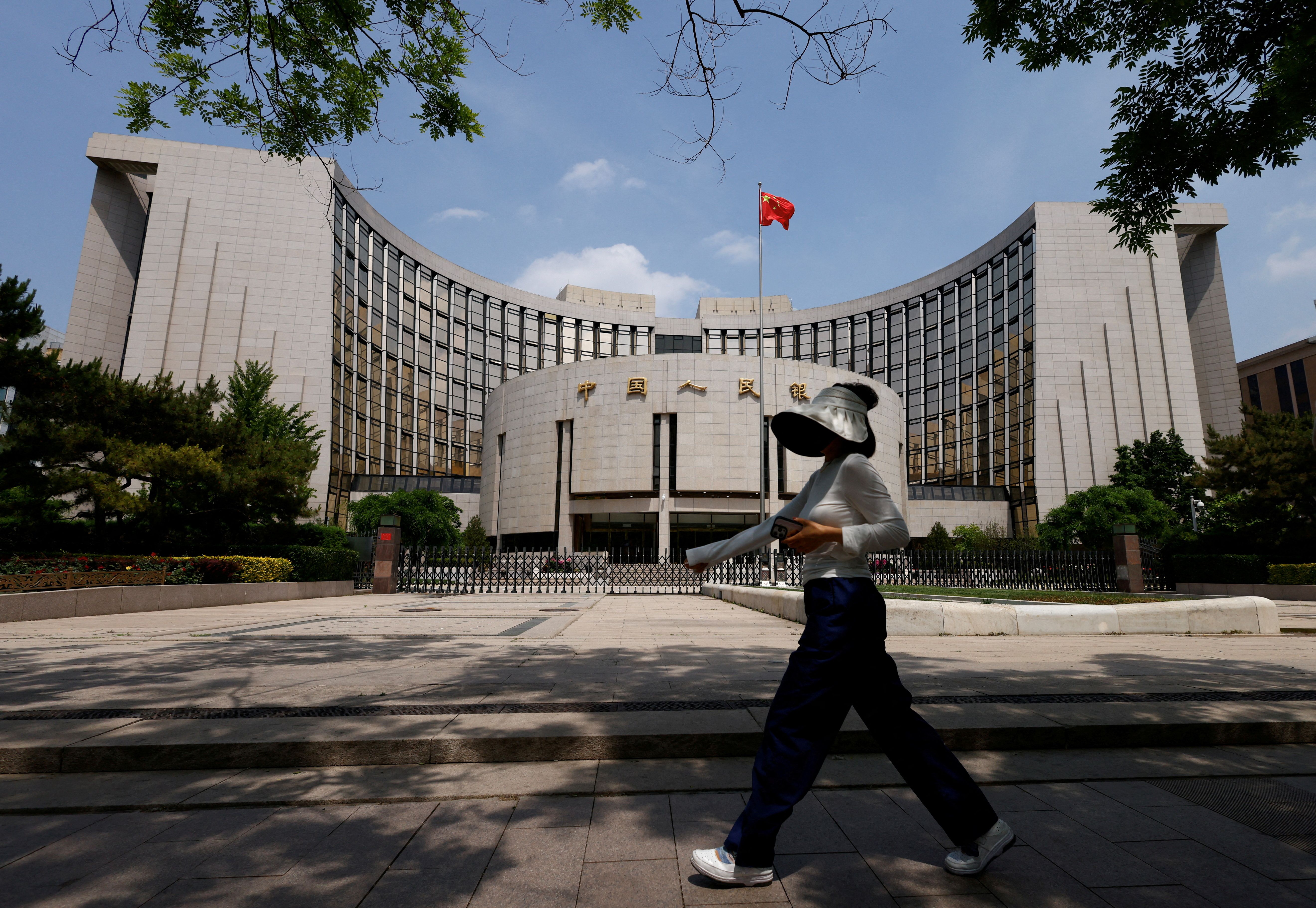 A person walks past the headquarters of the People’s Bank of China, in Beijing.