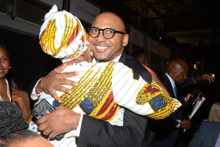Former Vodacom executive Romeo Kumalo hugs a woman.
