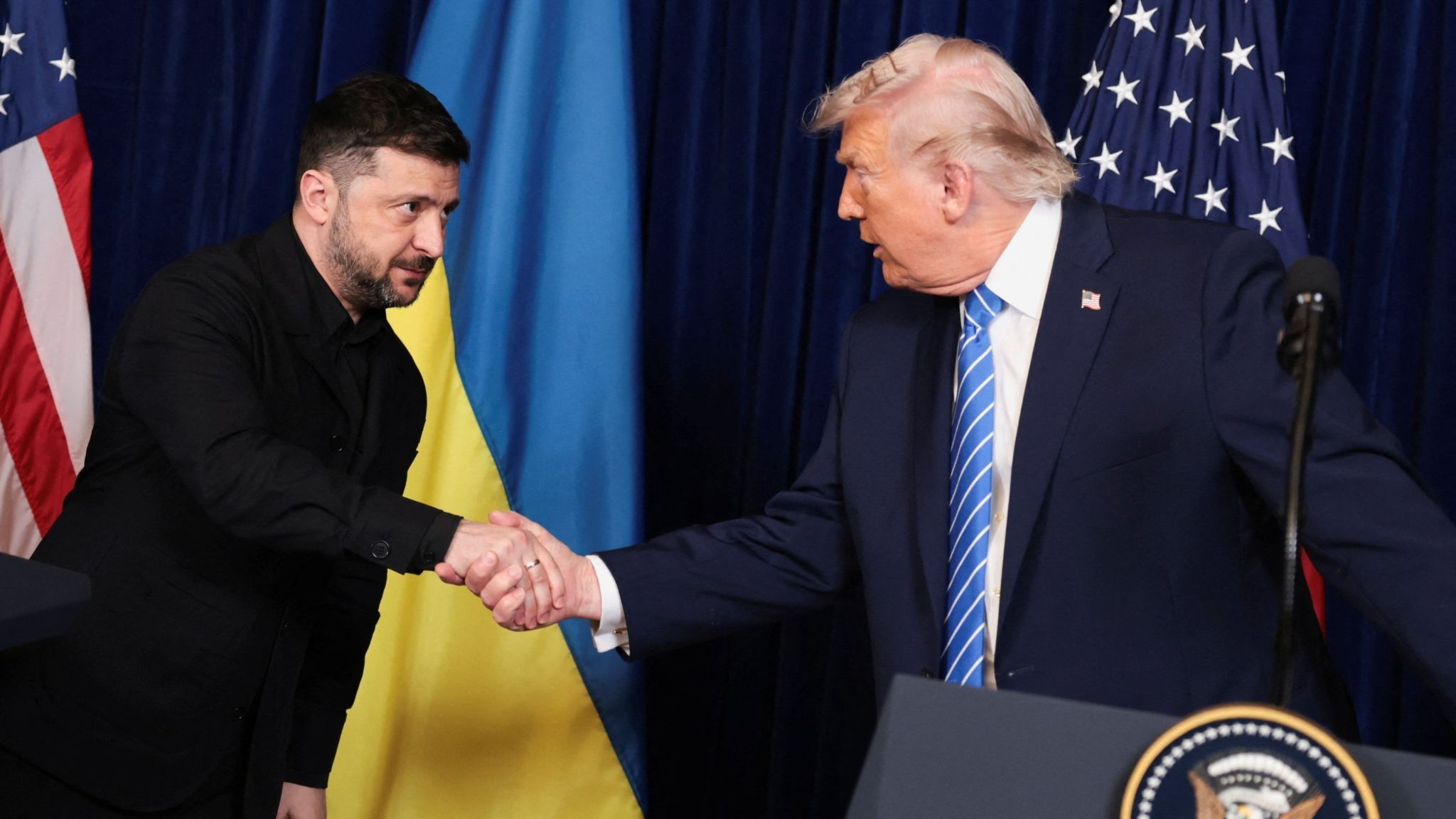 Ukrainian President Volodymyr Zelenskyy shakes hands with US President Donald Trump.