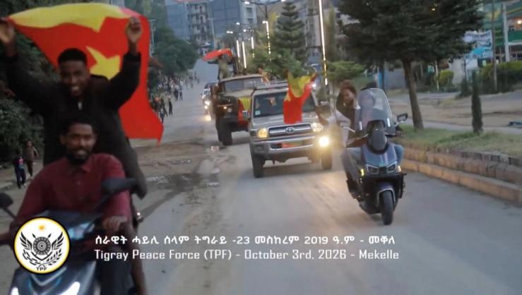 Men riding motorcycles wave flags of the Tigray region in Mekelle, Ethiopia.