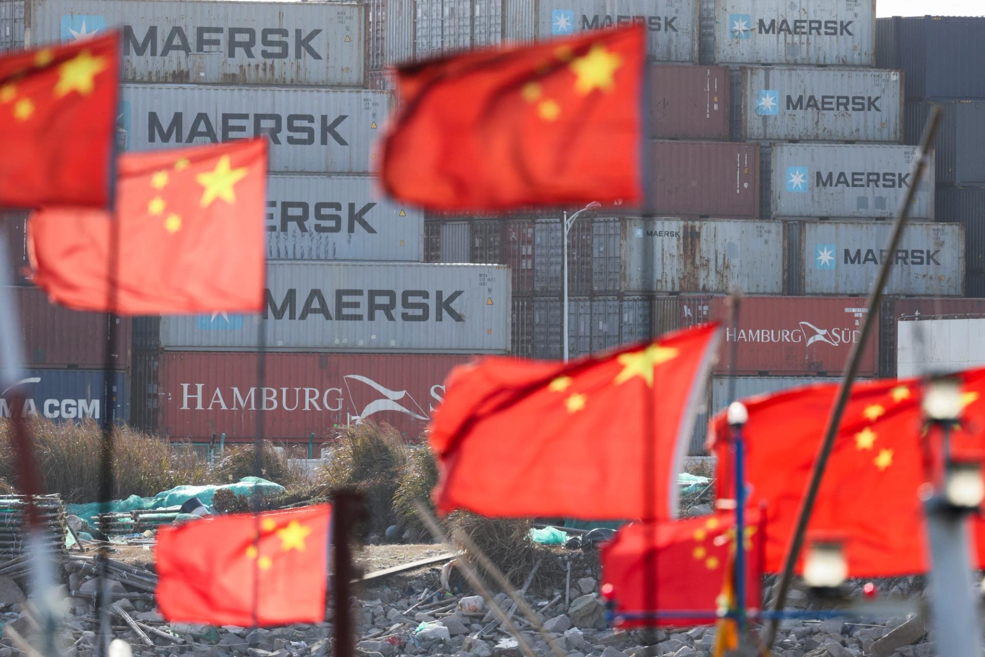 Chinese national flags flutter near shipping containers at the Yangshan Port outside Shanghai.