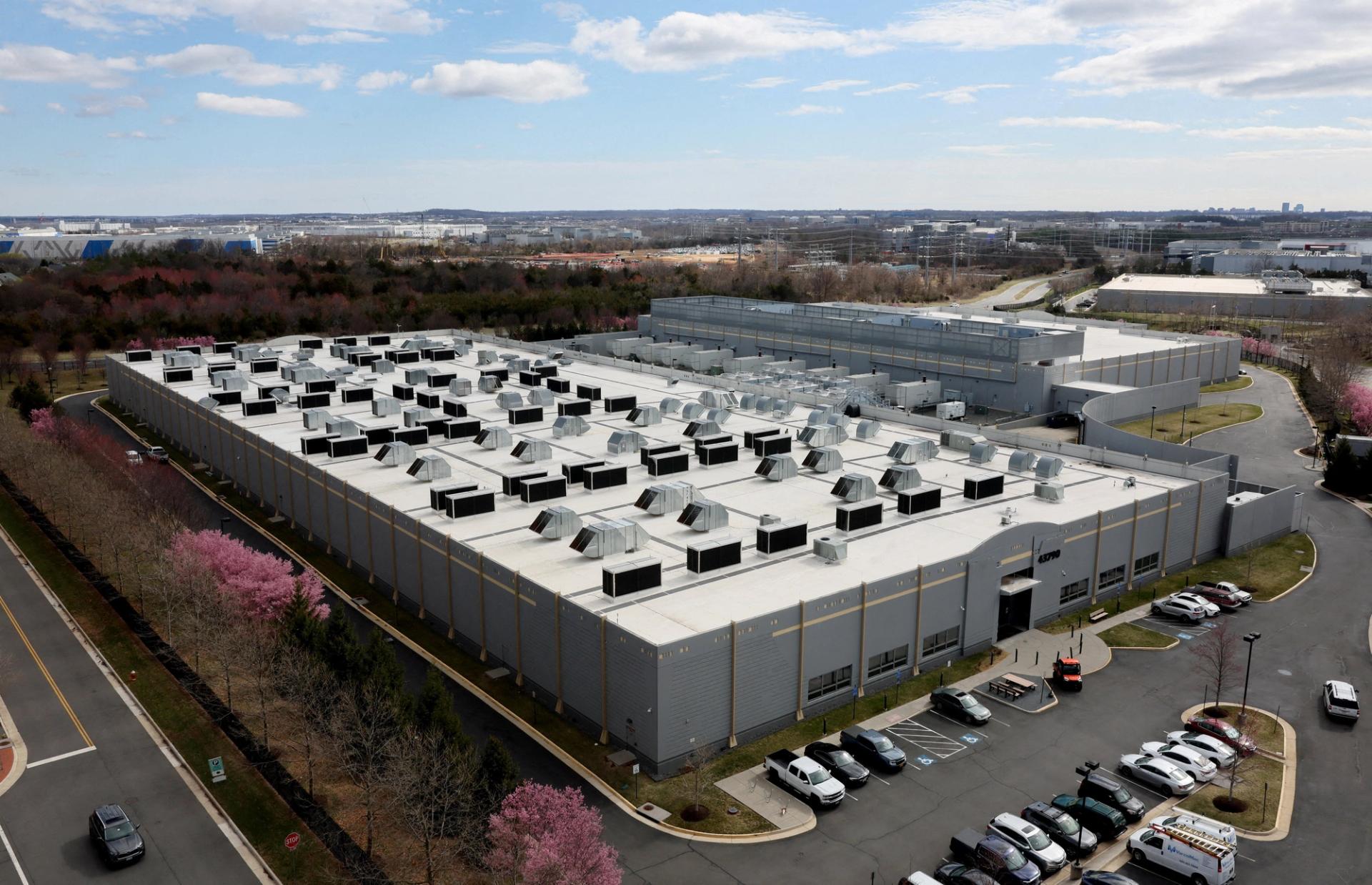 A car drives past a building of the Digital Realty Data Center in Ashburn, Virginia.