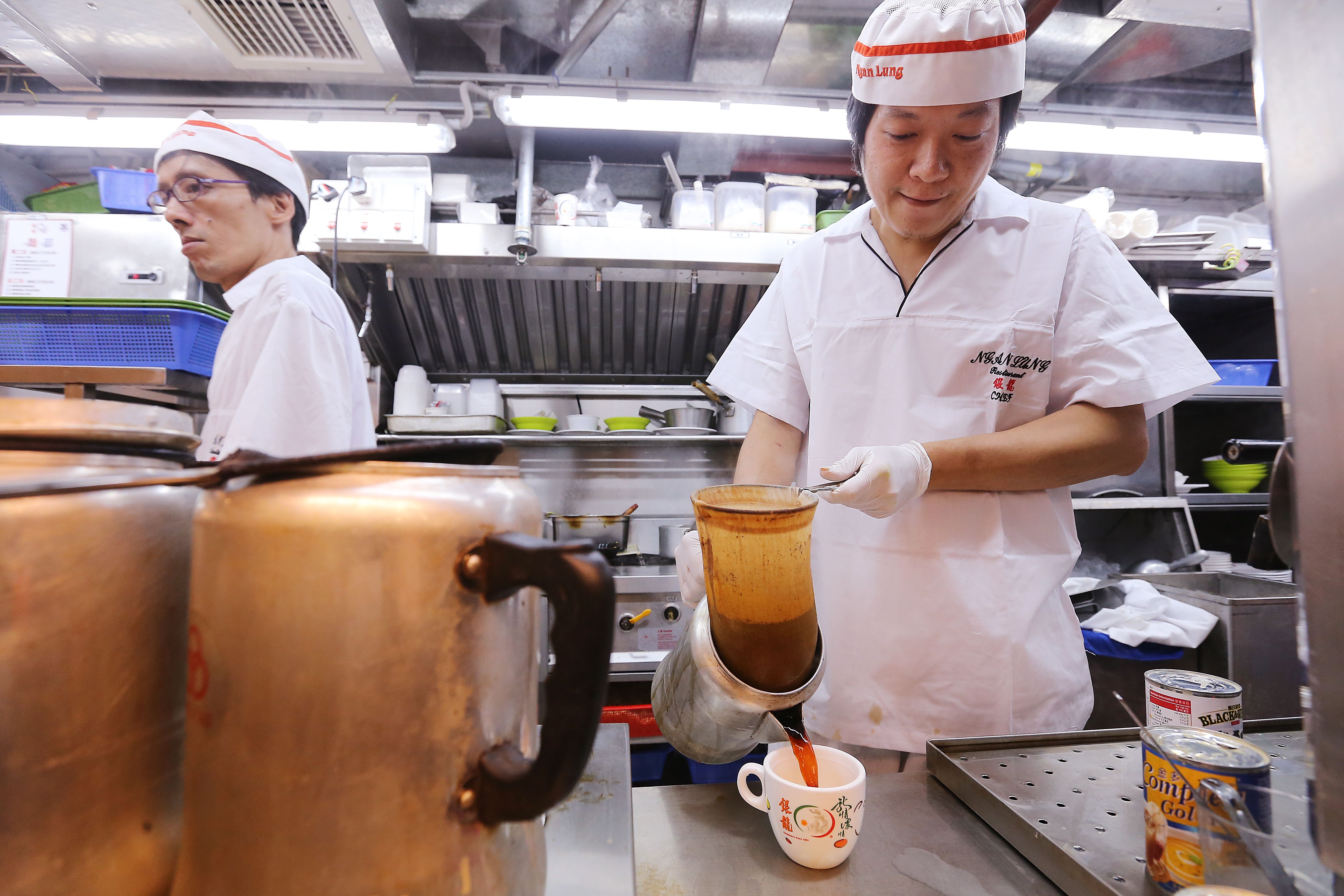 Staff making Hong Kong-style milk tea at Ngan Lung Catering Group (Cha Chaan Teng) in Mei Foo. 