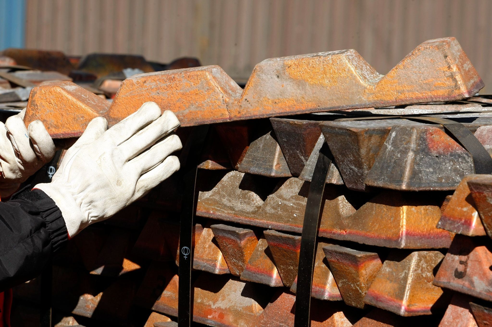 A worker checks a shipment of copper.