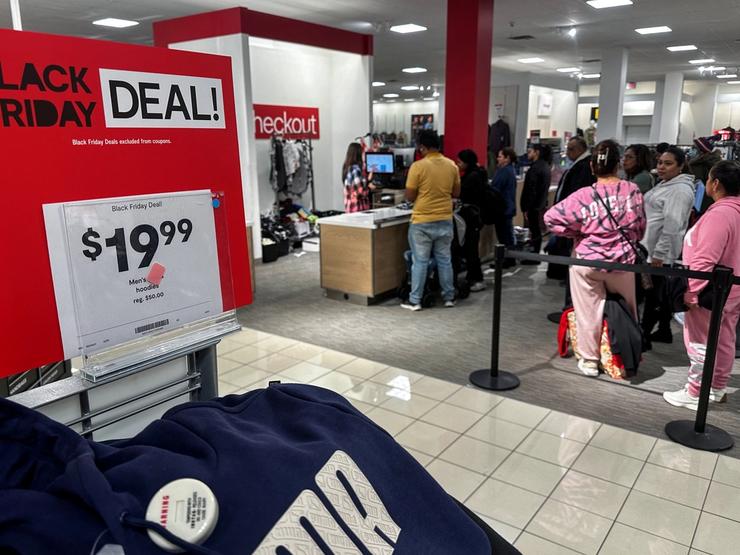 Shoppers wait in line to make purchases during Black Friday deals at JCPenney department store at Roosevelt Field mall in Garden City, New York.