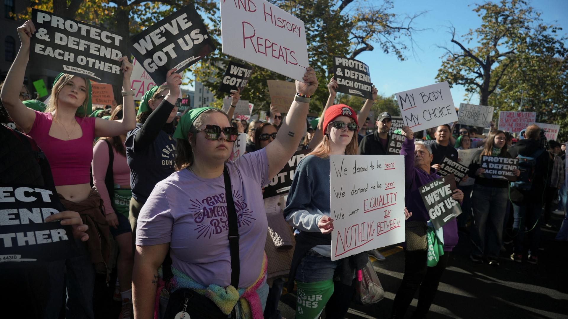 Protestors hold banners during a pro-women’s rights demonstration in Washington, DC, days after Trump’s victory in the US presidential election