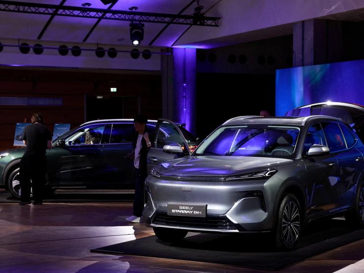 Journalists look at the Geely Starray EM-i car, a mid-sized plug-in hybrid SUV, presented during a press conference for the launching of Geely Auto France, in Paris, France,