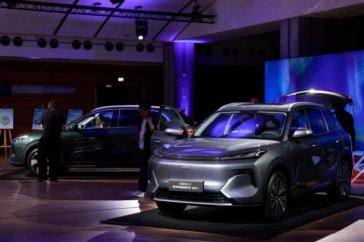 Journalists look at the Geely Starray EM-i car, a mid-sized plug-in hybrid SUV, presented during a press conference for the launching of Geely Auto France, in Paris, France,