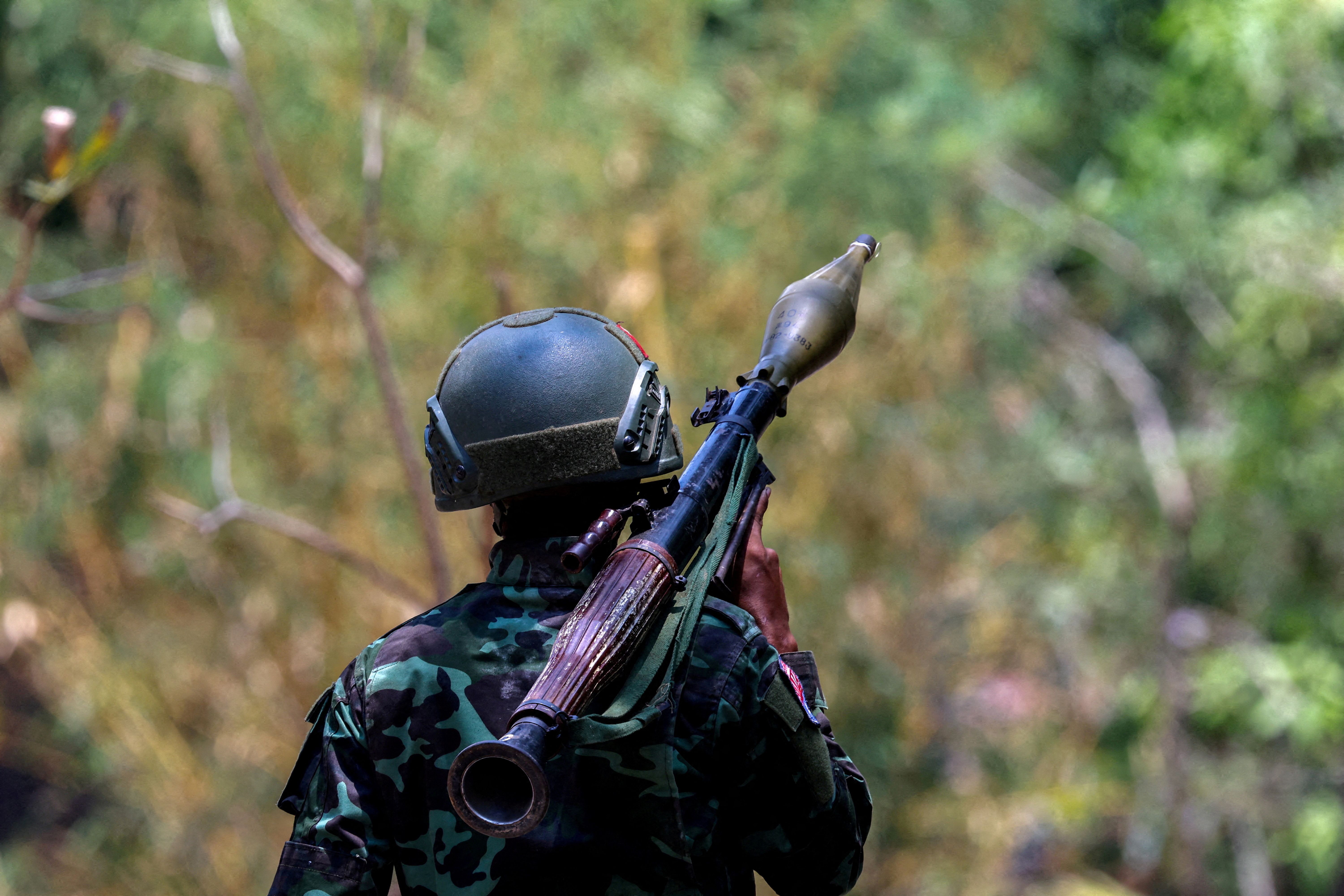 A Karen National Liberation Army soldier carries an RPG launcher at a Myanmar military base on the outskirts of Myawaddy, the Thailand-Myanmar border town  