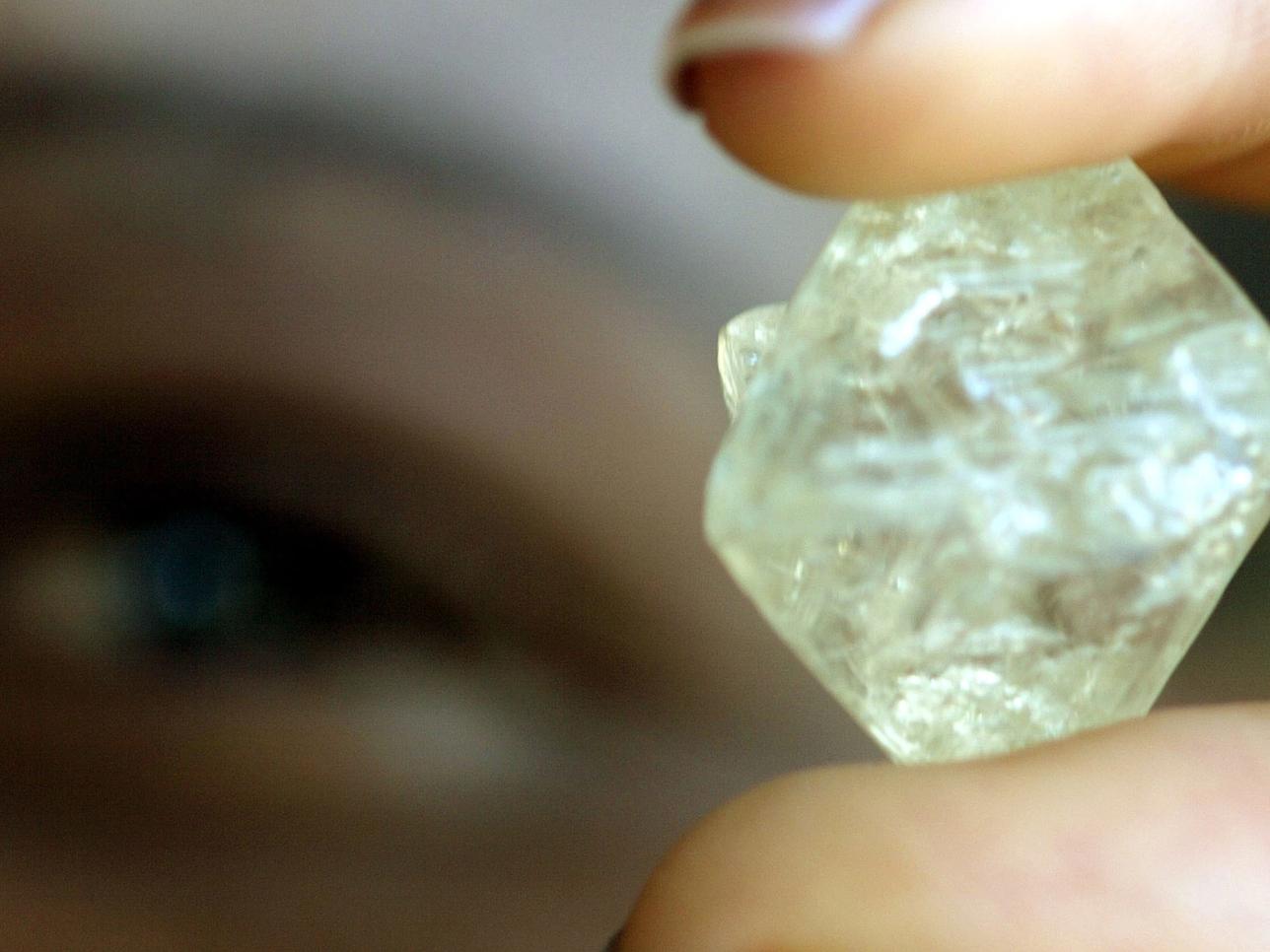 A worker at the Botswana Diamond Valuing Company displays a rough diamond.
