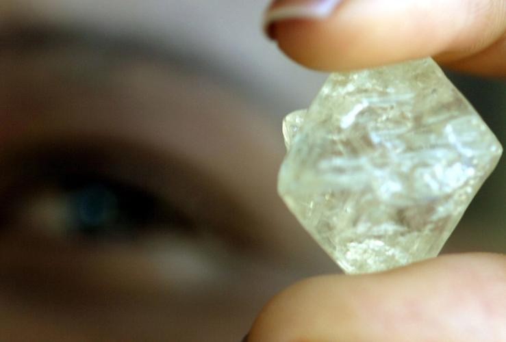 A worker at the Botswana Diamond Valuing Company displays a rough diamond.
