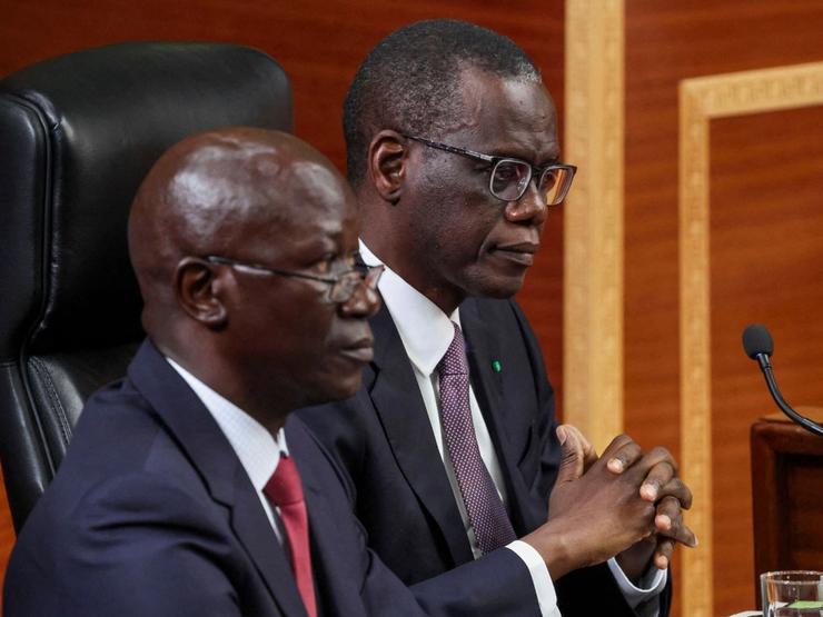 Senegal PM Ahmadou Al Aminou Lo, (right) sits as he arrives to deliver his first policy address to the National Assembly in Dakar.