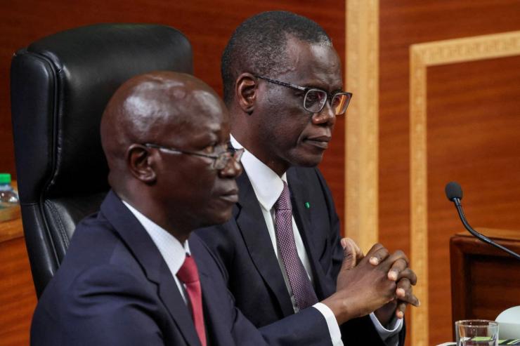 Senegal PM Ahmadou Al Aminou Lo, (right) sits as he arrives to deliver his first policy address to the National Assembly in Dakar.