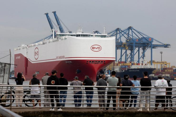 People stand in front of the BYD vessel in Brazil.
