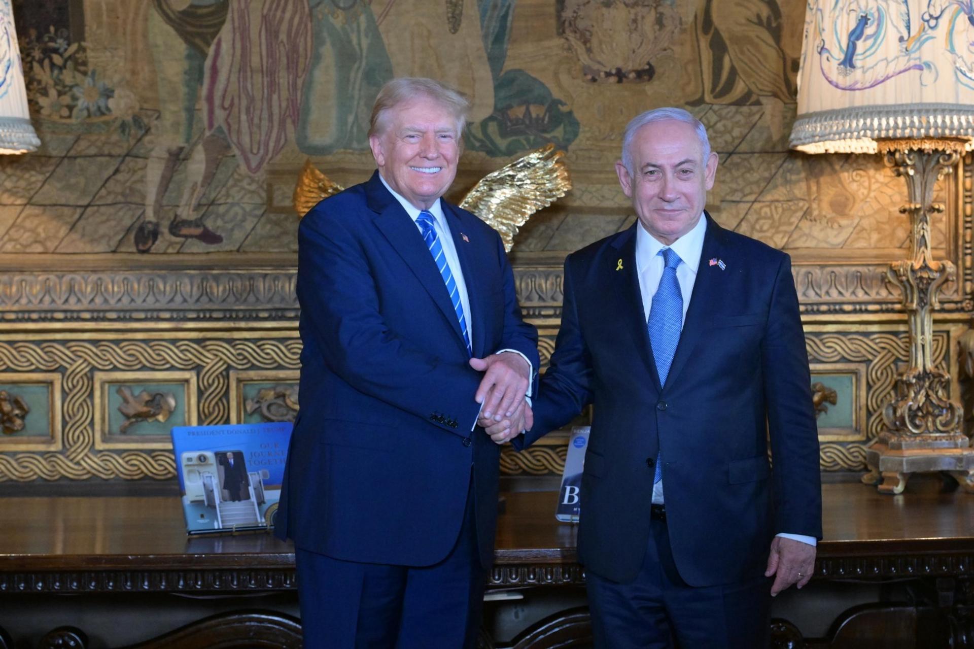 Former US President Donald Trump shakes hands with Israeli Prime Minister Benjamin Netanyahu as they pose for a photo at Trump’s Mar-a-Lago estate in Palm Beach, Florida, on July 26, 2024.