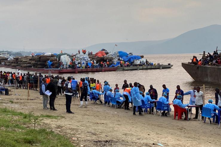 Passengers who disembarked from a boat intercepted by health authorities wait to be tested for Ebola in Kinasha