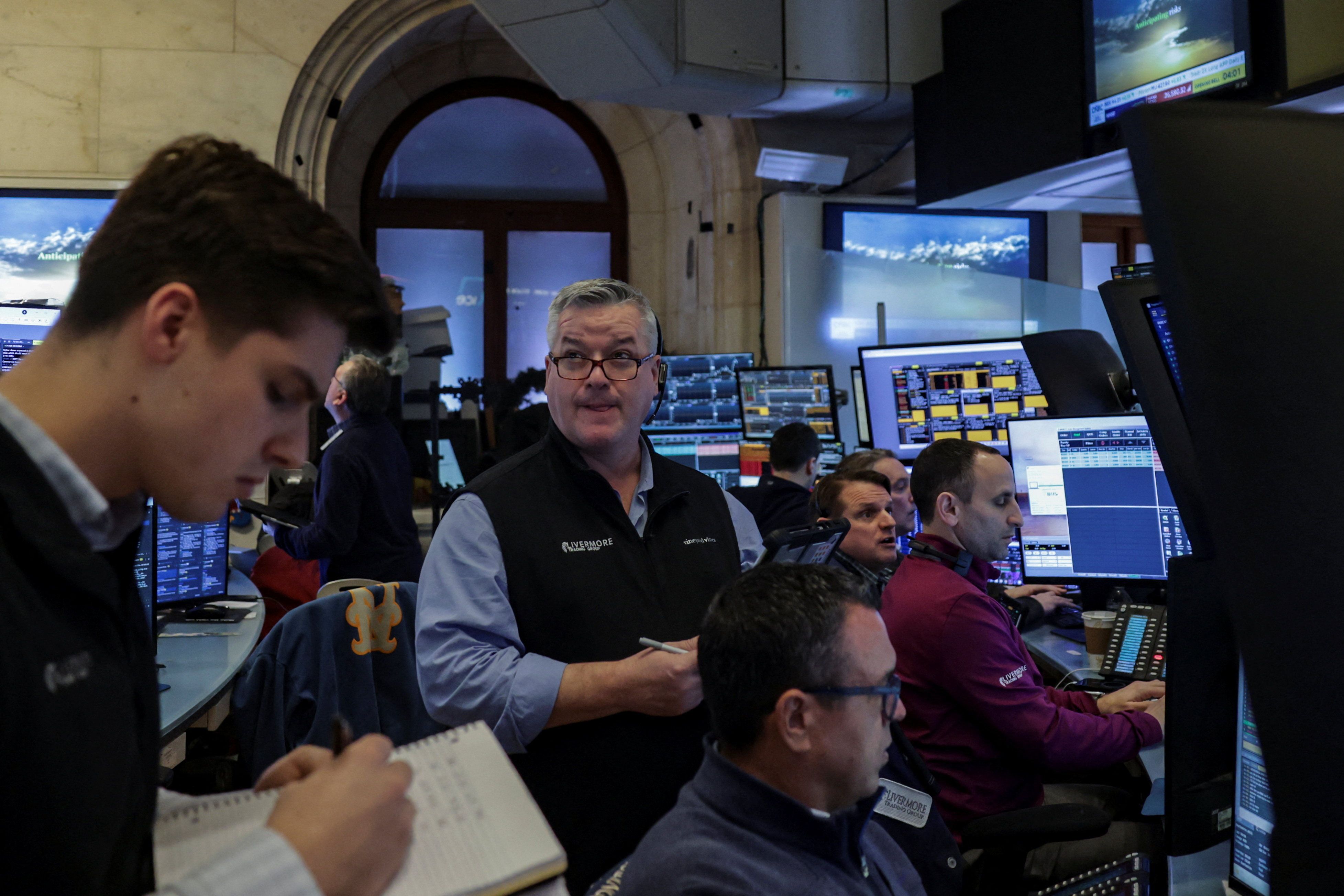 Traders work on the floor at the New York Stock Exchange (NYSE)