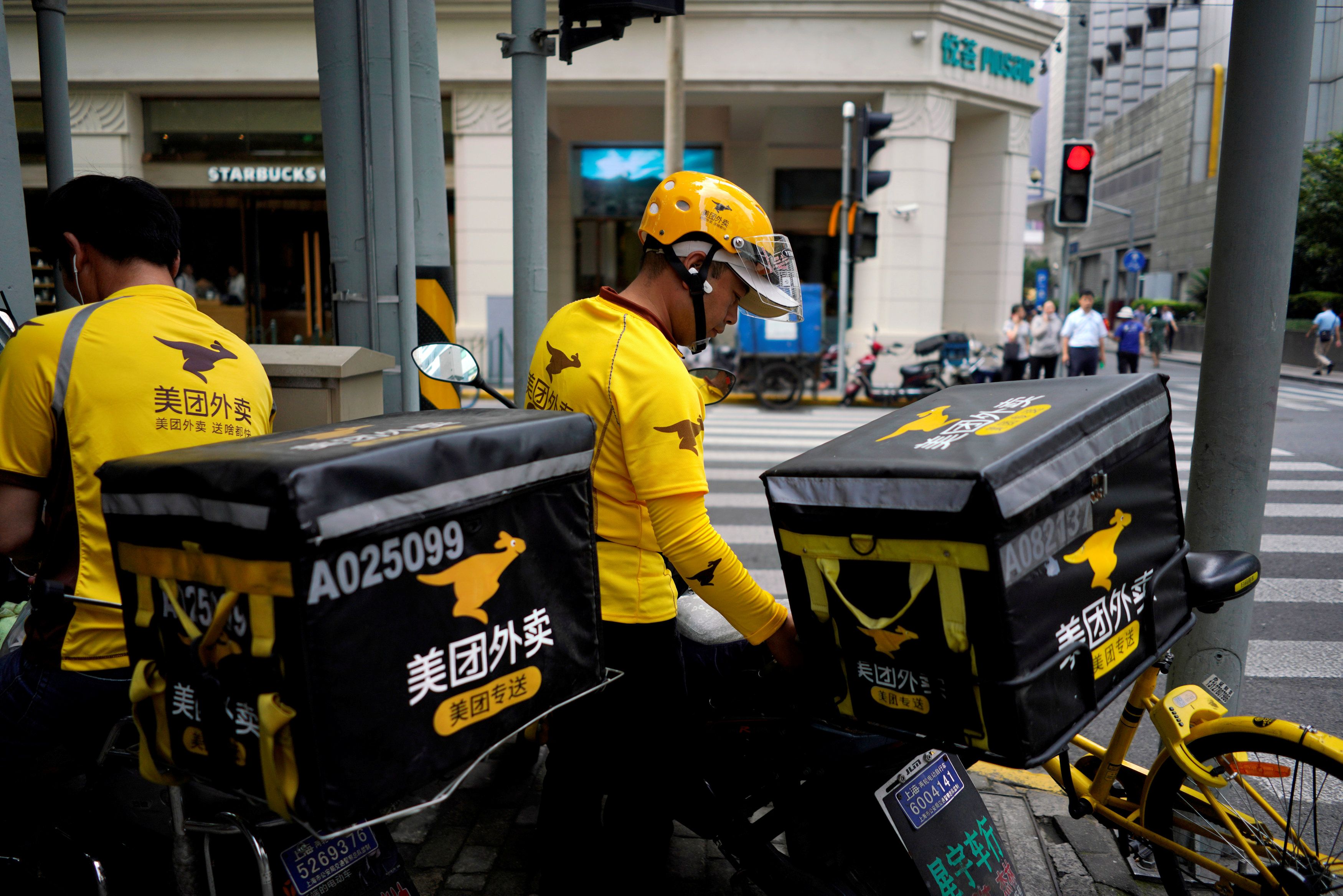 Drivers of food delivery service Meituan are seen in Shanghai, China 