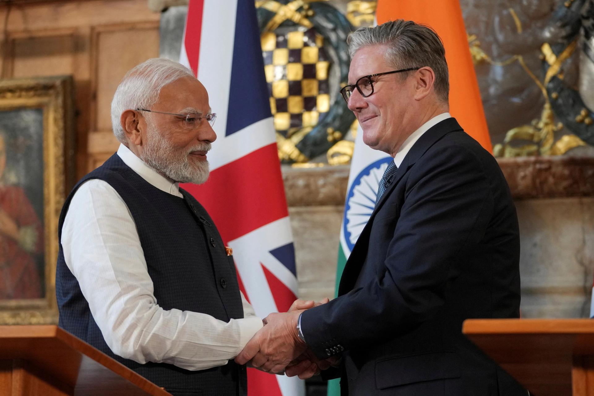 Britain’s Prime Minister Keir Starmer and Prime Minister Narendra Modi of India shake hands after signing a free trade agreement.