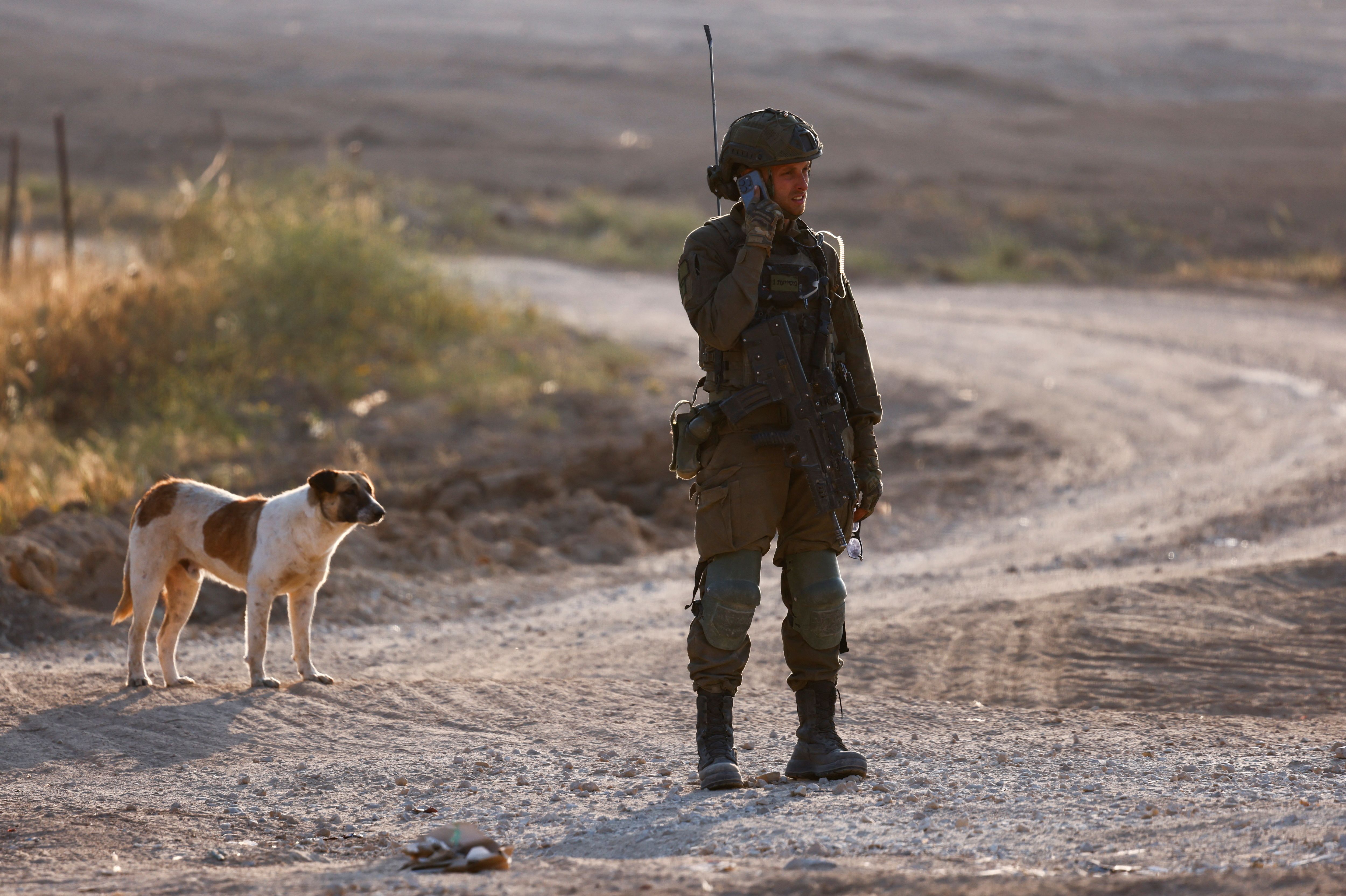 An Israeli soldier speaks on a phone before entering Gaza, amid the ongoing conflict between Israel and the Palestinian Islamist group Hamas, at Israel’s border with Gaza in southern Israel, April 7, 2024. REUTERS/Amir Cohen